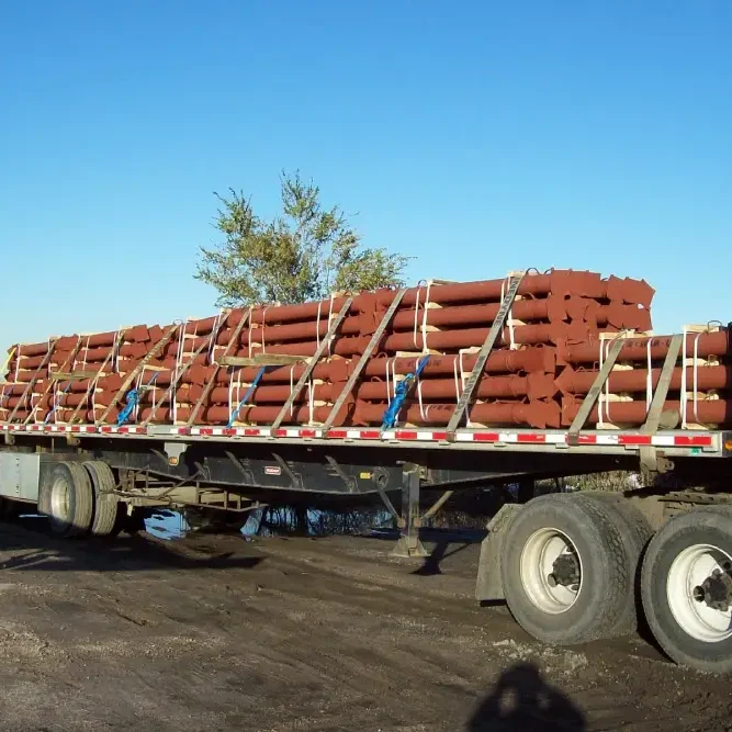 A flatbed truck loaded with pipes